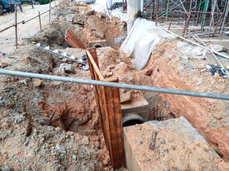 Téléchargez les photos : Melaka, Malaisie - 2 février 2022 : Trou d'homme utilitaire en construction sur un chantier de construction. Construit sur place selon la conception de l'ingénieur. Utilisation du contreplaqué et du bois comme moule de construction - en image libre de droit