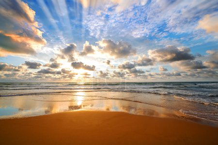 Foto de Colorido océano playa amanecer con cielo azul profundo y rayos de sol. - Imagen libre de derechos