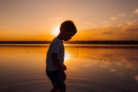 Photo for Silhouette of male child in sunlight rays. Fresh air, environment concept. - Royalty Free Image