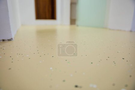 Photo for A medical facility with new decorative epoxy flooring. Colorful chips embedded in the seamless surface create a vibrant and durable solution.Selective focus - Royalty Free Image