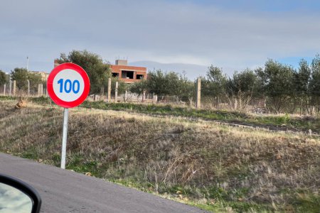 Photo for 100 Km speed limit signpost on the roadside of a highway - Royalty Free Image