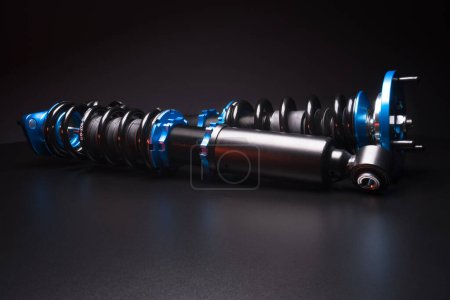 Photo for Auto suspension tuning coilovers shock absorbers and springs blue for a sports drift car on a dark background - Royalty Free Image
