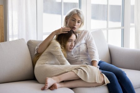 Loving mum stroking her frustrated pre-teen daughter, give emotional support, feeling empathy, give advice, having good trustful relationship between teenager and parent. Adolescence problems, care