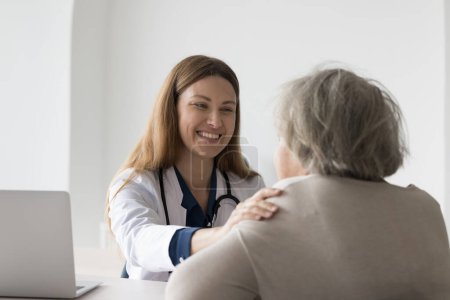 Photo for Positive happy practitioner seeing older patient, touching shoulder, giving medical advice for treatment, healthcare, assistance, support, explaining optimistic diagnosis - Royalty Free Image