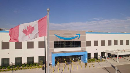 Photo for Toronto, Ontario, Canada - September 11, 2022: Amazon logo on the new build modern building. Amazon Smile Arrow logo and brand trademark. Fulfillment center warehouse and office building. - Royalty Free Image