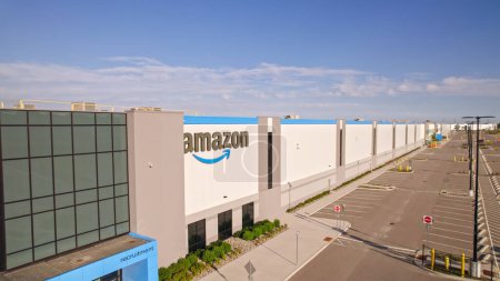 Photo for Toronto, Ontario, Canada - September 11, 2022: Aerial view of Amazon logo brand name and trademark at distribution center warehouse Entrance. Large storage facility and office headquarter. - Royalty Free Image
