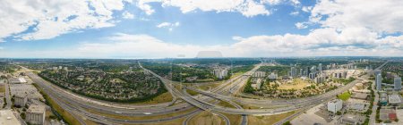 Photo for Highway for high speed commute and road traffic avoidance. Cars transportation junction development. Expressway in Canada view from above. Exit or entrance road lanes with speed ramps. - Royalty Free Image