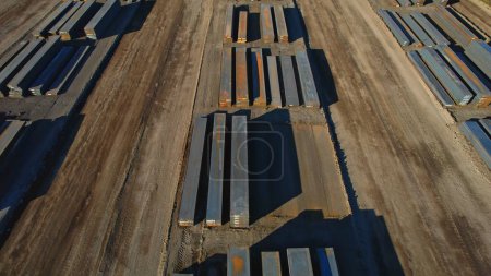 Photo for View of made steel billets and slabs in urban area of steel factory manufacturing. Steel used for production of auto EV electric motor, packaging beverage cans and construction. - Royalty Free Image