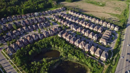 Photo for Panoramic view at established neighbourhood with town home cottage style houses in Canada. Top aerial view at middle class family homes with large backyard and green front yards. Very clean area. - Royalty Free Image