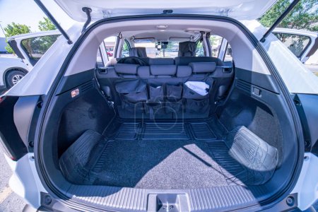 Photo for Empty car trunk open view with backseat car organizer with storage pockets. Modern hatchback SUV vehicle open cargo area. The automobile boot is open for luggage. Preparation for travel concept. - Royalty Free Image