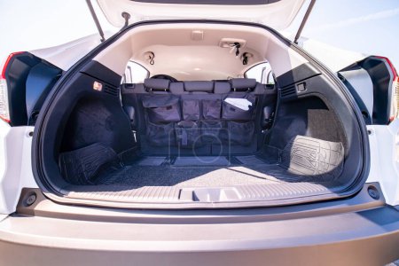 Photo for Empty car trunk open view with backseat car organizer with storage pockets. Modern hatchback SUV vehicle open cargo area. The automobile boot is open for luggage. Preparation for travel concept. - Royalty Free Image