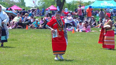 Foto de Pow Wow, 2nd Annual Two Spirit Powwow, by 2-Spirited People of the 1st Nations. Youth and women traditional dance in colourful dress: Toronto, Ontario, Canada - May 27, 2023. - Imagen libre de derechos