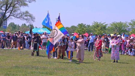 Photo for Display of flags at Two Spirits Pow wow. Pride flag with 2-Spirited Native American symbol. Trans or Transgender. Metis Flag and missing in action POW MIA flag: Toronto, Ontario, Canada - May 27, 2023 - Royalty Free Image