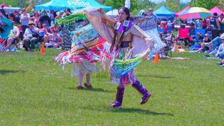 Photo for Pow Wow, 2nd Annual Two Spirit Powwow, by 2-Spirited People of the 1st Nations. Youth and women traditional dance in colourful dress: Toronto, Ontario, Canada - May 27, 2023. - Royalty Free Image