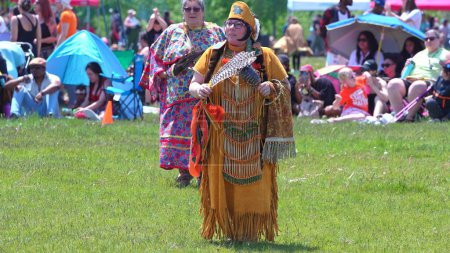Foto de Pow Wow, 2nd Annual Two Spirit Powwow, by 2-Spirited People of the 1st Nations. Senior women traditional dance in colourful dress: Toronto, Ontario, Canada - May 27, 2023. - Imagen libre de derechos
