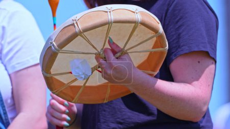 Téléchargez les photos : Jeunes artistes utilisant des tambours à main ou des tambours lors du 2e pow-wow bispirituel annuel de Toronto, animé par des personnes bispirituelles des Premières Nations. - en image libre de droit