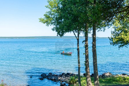 Photo for View to the beautiful Lake Manitou from the cabin. Amazing sky line landscape with trees and water. Canadian wilderness. Perfect spot for a holiday. Cottage located on the largest fresh water island. - Royalty Free Image