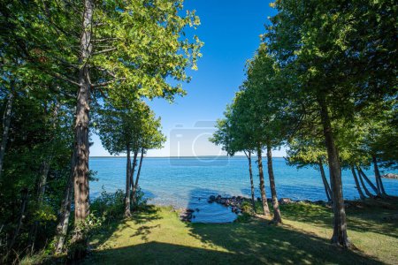 Photo for View to the beautiful Lake Manitou from the cabin. Amazing sky line landscape with trees and water. Canadian wilderness. Perfect spot for a holiday. Cottage located on the largest fresh water island. - Royalty Free Image