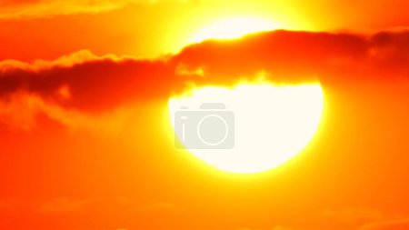 Photo for Big bright yellow hot sun disk moves down as sunset. Epic sky and sky line. Amazing orange red yellow colors of the setting sun dusk. Vibrant colors and sun set. - Royalty Free Image