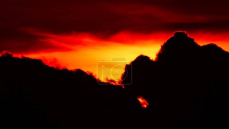 Photo for Clouds set at red yellow and orange sky. Hot summer atmosphere at heat wave. Yellow setting at epic golden hour time lapse. - Royalty Free Image