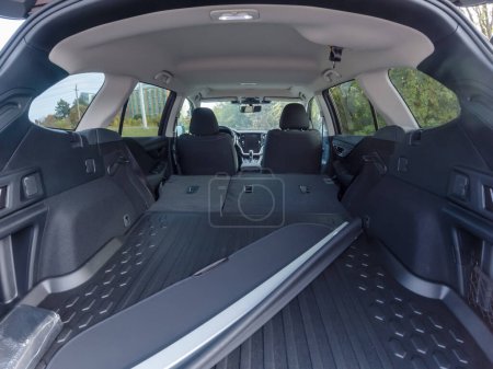 Photo for Empty car trunk open view with backseat down and storage cover. New car purchase PDI. Modern SUV vehicle open cargo area. The automobile boot is open for luggage. Preparation for travel concept. - Royalty Free Image