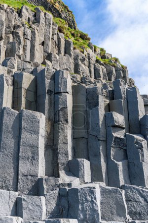 Basalt columns at the base of Reynisfjall cliff in the Reynisfjara beach in southern Iceland cliff