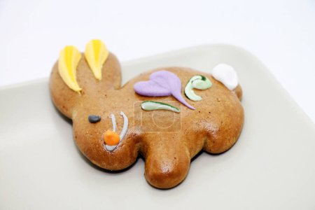 Photo for Easter cookie in the shape of a bunny on the plate. Studio shot. - Royalty Free Image