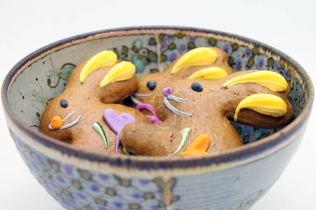 Photo for Easter gingerbread cookies in the shape of a bunny in a bowl. View from above. - Royalty Free Image