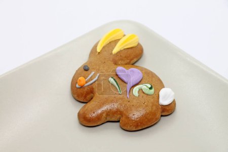Photo for Easter cookie in the shape of a bunny on the plate close-up. Studio shot. - Royalty Free Image