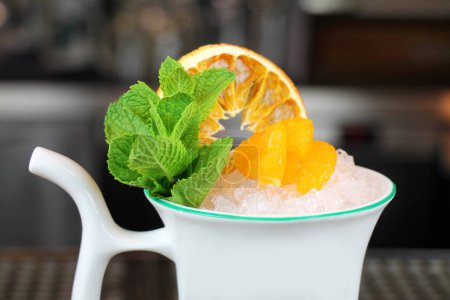 Photo for Fruit cocktail in a spa cup at a defocused background close-up. - Royalty Free Image