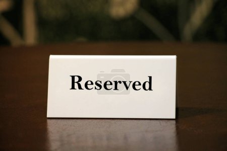 Photo for Reservation card on wooden table closeup. - Royalty Free Image