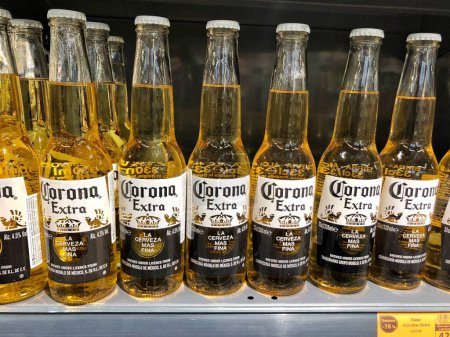 Photo for 22.01.2023 Ukraine, Kharkiv, a shelf in a supermarket with beer from glass bottles. Light beer Korona Extra - Royalty Free Image