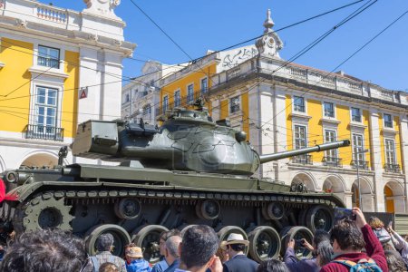 Photo for Crowds celebrate the 50th anniversary of the april 25th revolution, featuring a military tank in lisbon - Royalty Free Image