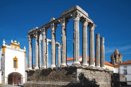 Ruins of the ancient Roman temple of Evora against a blue sky. Ancient Roman Temple of Diana. Evora, Portugal.