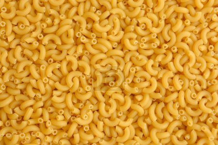 Top view of Italian uncooked pipe pasta. Food texture.