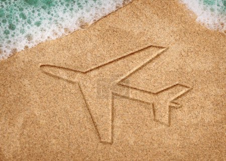 Photo for Sandy beach with drawing of a Plane in the sand or symbol. - Royalty Free Image