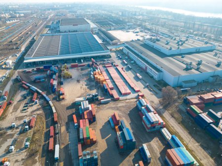 Cargo trains close-up. Aerial view of colorful freight trains on the railway station. Wagons with goods on railroad. Heavy industry. Industrial conceptual scene with trains. Top view from flying drone