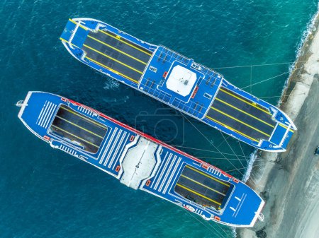 Photo for Aerial top down view of two ferry vessels docking near Antirrio after carrying passengers and trucks across the Gulf of Corinth in Greece - Royalty Free Image