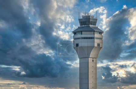 Foto de Torre de control de tráfico aéreo contra cielo nublado dramático del atardecer - Imagen libre de derechos
