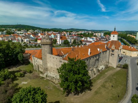 Photo for Aerial view of Strakonice castle next to the Otava river in Czechia with Gothic, Baroque palace and restored circular donjon with edge called Rumpal tower - Royalty Free Image