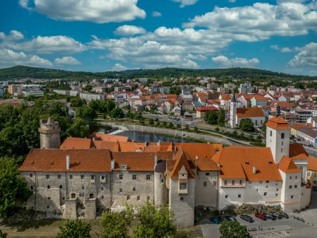 Photo for Aerial view of Strakonice castle next to the Otava river in Czechia with Gothic, Baroque palace and restored circular donjon with edge called Rumpal tower - Royalty Free Image