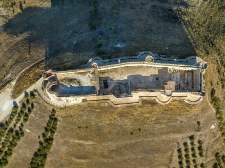 Aerial view of restored Jadraque medieval hilltop castle in Spain in in the province of Guadalajara, CastillaLa Mancha, above the Henares river, with concentric towers blue sky with jet streams