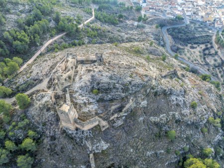 Aerial view of Pliego town and medieval castle in Southern Spain, ruined walls made of rammed earth with Arab origin