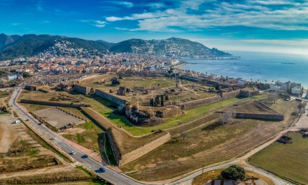 Photo for Panoramic aerial view of Roses citadel in Spain , giant pentagonal star fort fortress with bastions on each angle, ruins of medieval city, Roman ruins, monastery on the courtyard - Royalty Free Image