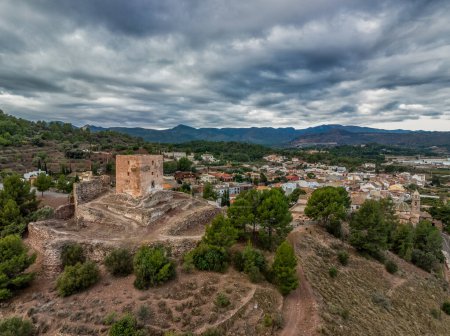 Aerial view of Torres Torres medieval castle ruin with square keep and semi circular towers near Valencia Spain with dramatic sky