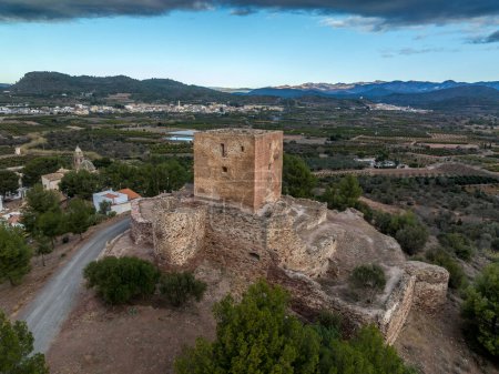 Aerial view of Torres Torres medieval castle ruin with square keep and semi circular towers near Valencia Spain with dramatic sky