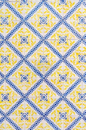 Photo for Fragment of building wall with yellow and blue ceramic wall tiles Azulejo Abstract decorative background textured ornate pattern. Traditional ornate Portuguese architecture - Royalty Free Image