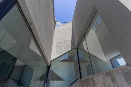 Close-up detail of a modern residential building with grey concrete and glass