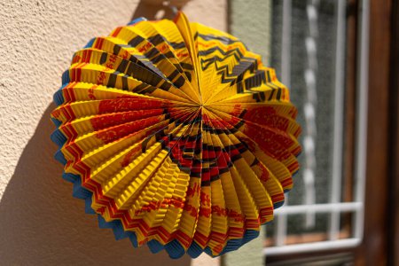 Traditional San Juan festival paper decoration near window