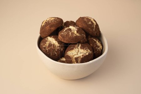 Cinnamon crinkle cookies in a bowl on the beige background